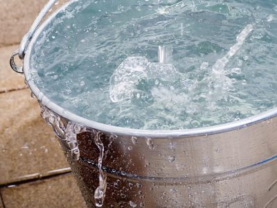 Why Sound changes while filling up a bucket with water?